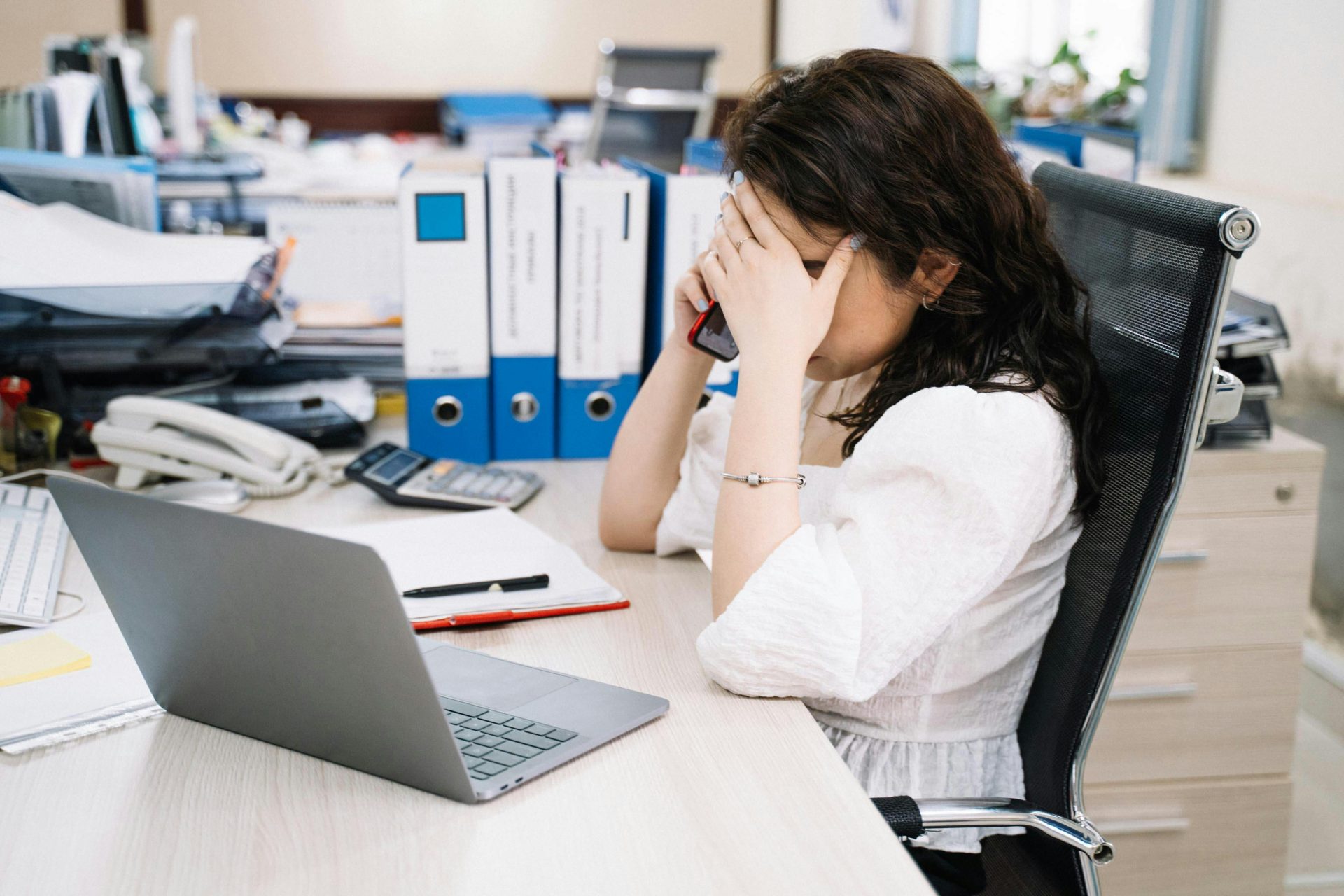 Office person talking on the phone while working