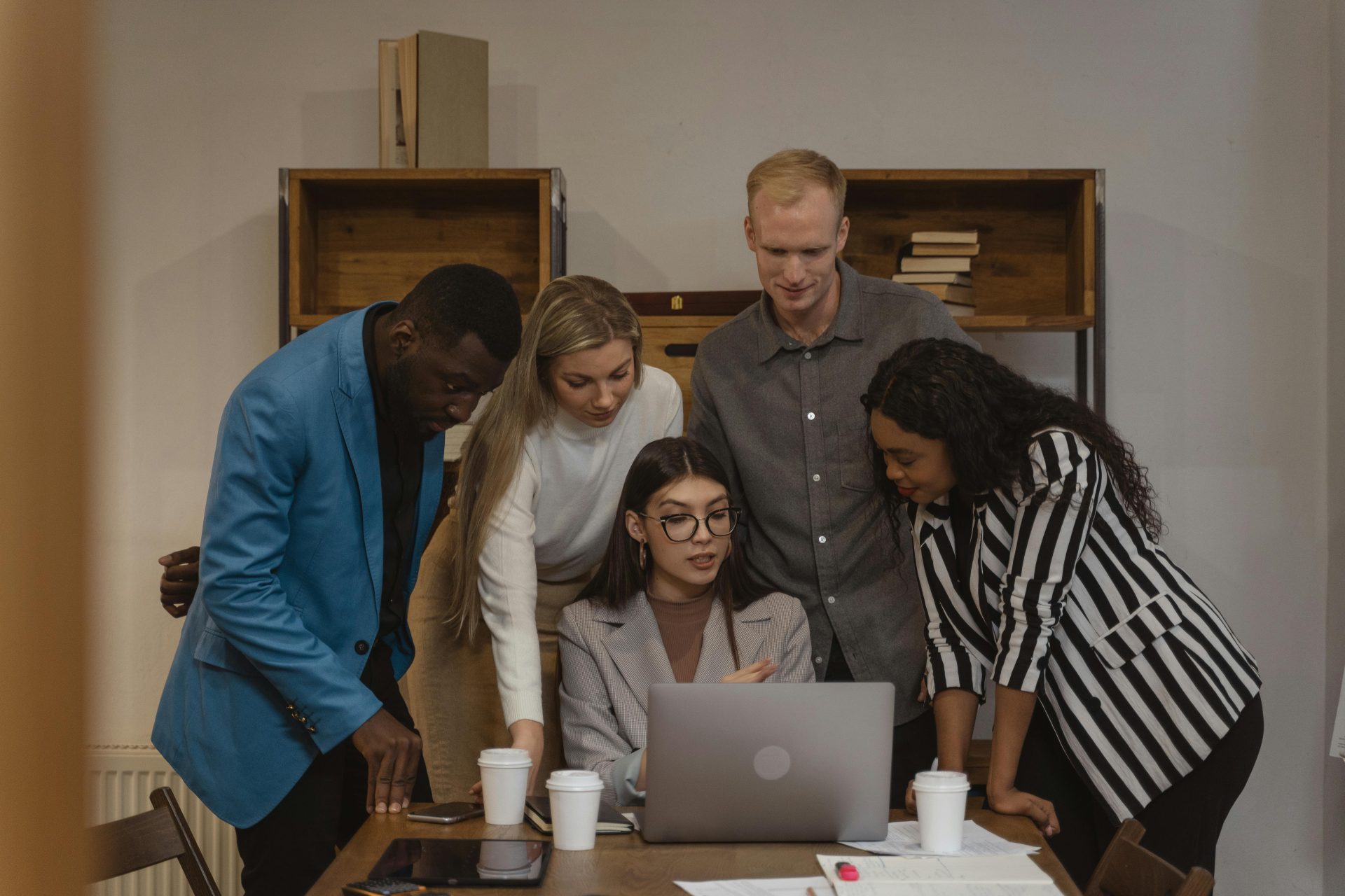 Several people looking at a laptop
